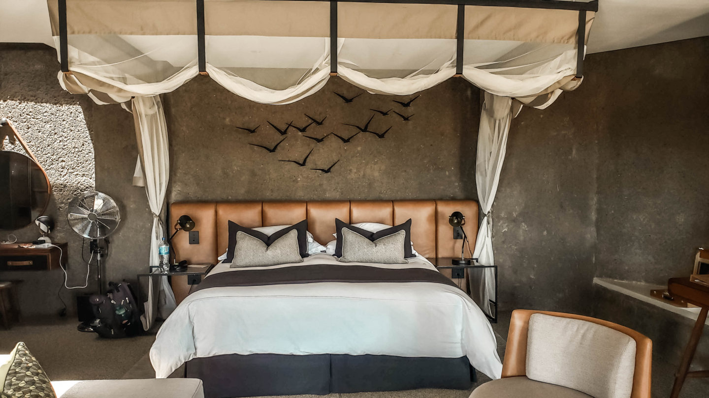 king-sized bed, luxury safari lodge, earth tones
